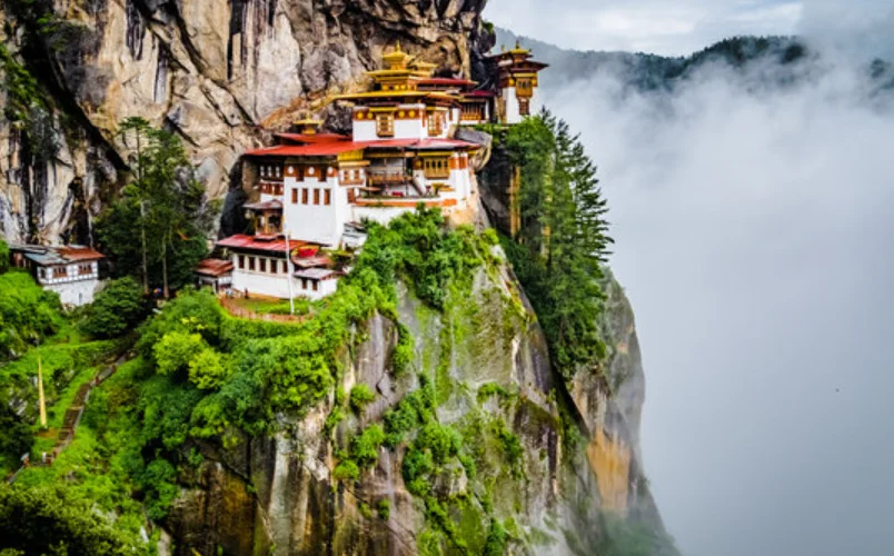 Trekker arriving at Tiger's Nest Monastery above Paro Valley after Bumdra Trek in Bhutan